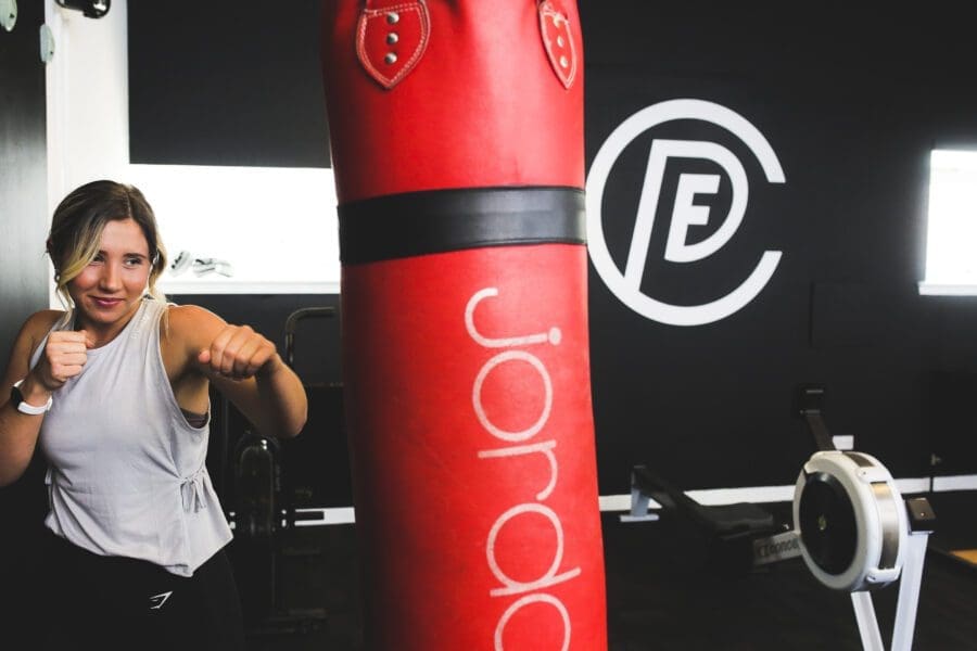Female Gym Member using Punch Bag Female Gym Member using Punch Bag