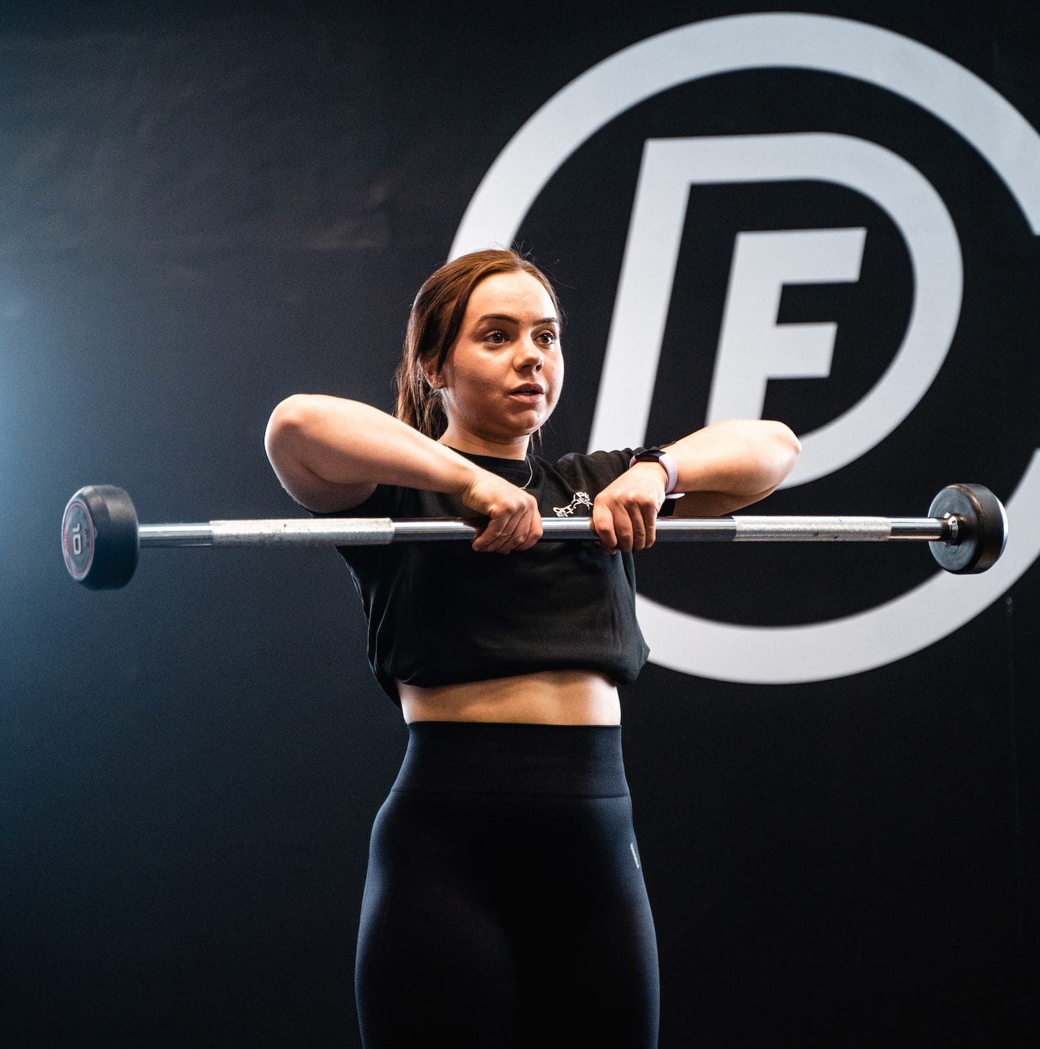 Female PT Student doing weights in her fitness qualifications
