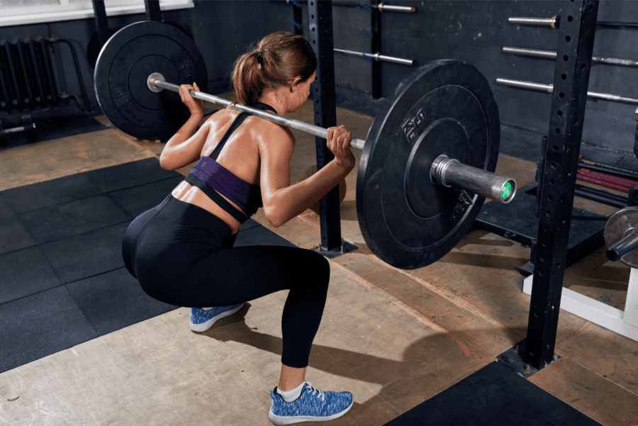 back view of women doing a squat