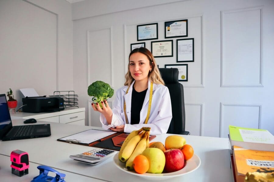 dietitian vs nutritionist professional at desk with food