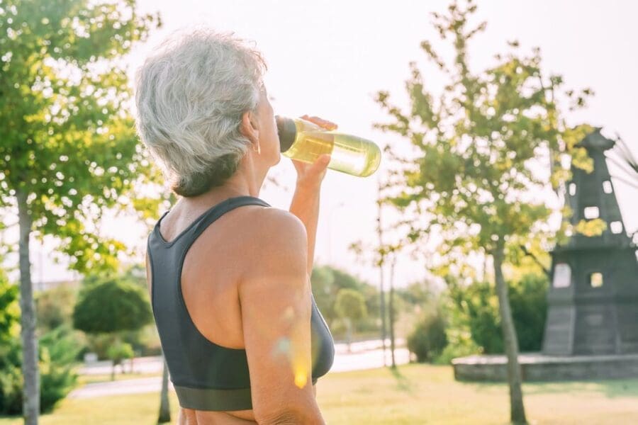 An elderly athlete hydrating An elderly athlete hydrating