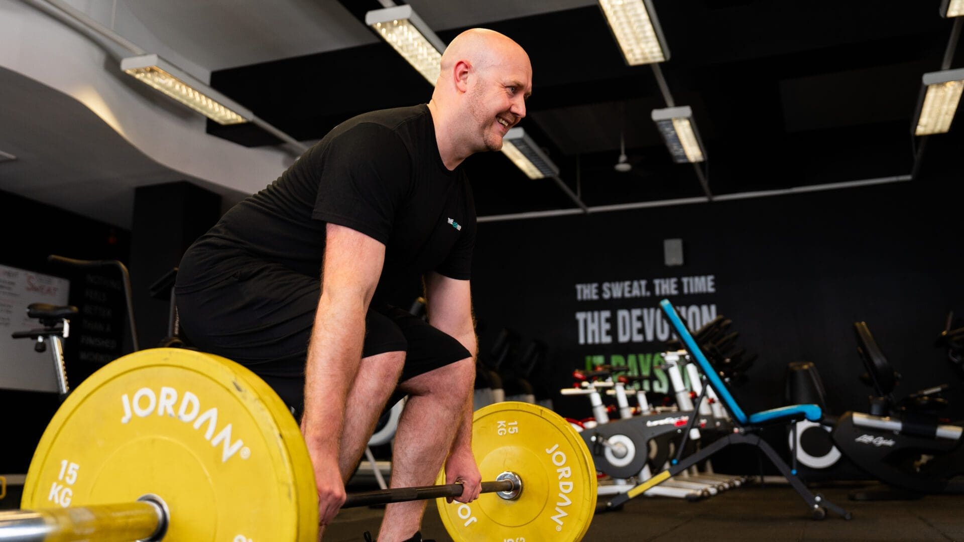 man weightlifting using a barbell