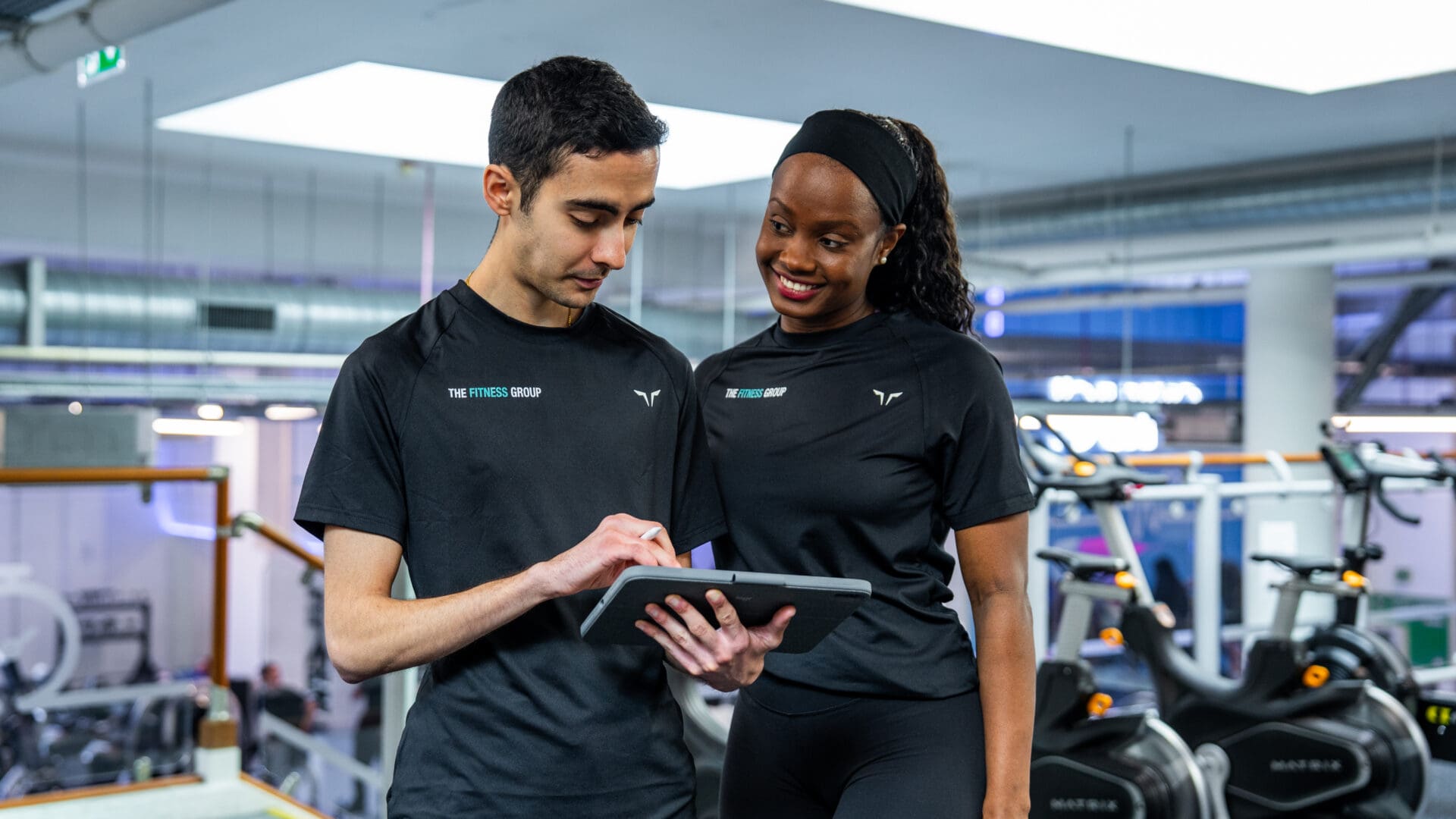 Two Personal trainers working in the gym.